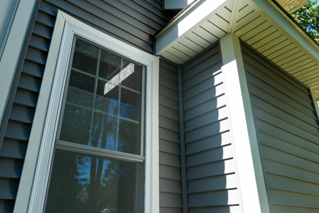 New vinyl siding and window treatments at a residential home.