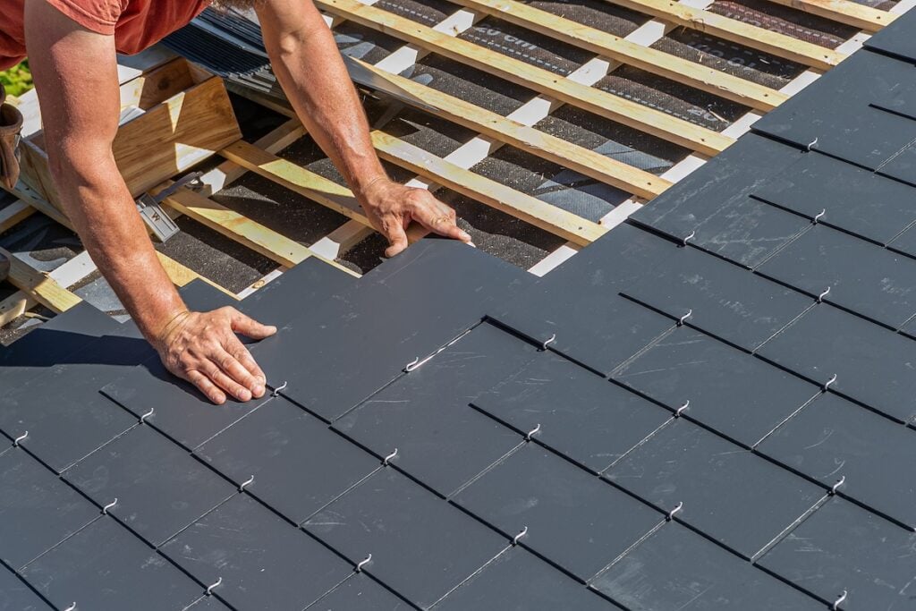 Craftsmen are installing a slate roof home