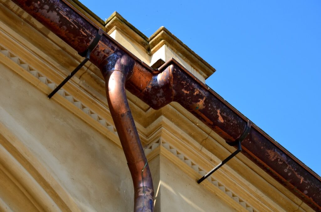 Copper eaves on a beige historic building