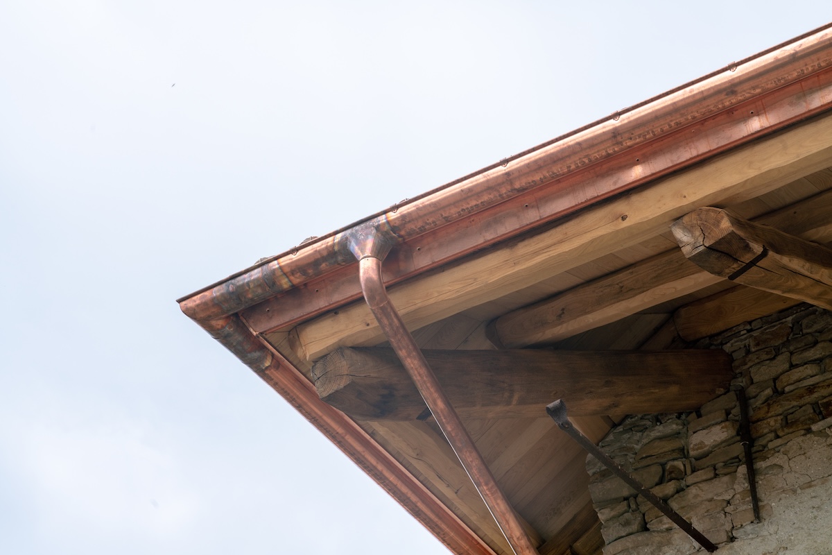 house roof, building renovation with copper gutter