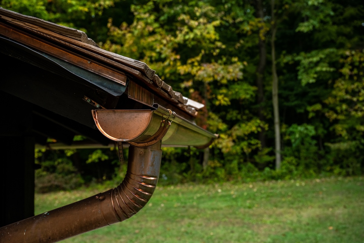 Copper Gutters Along Wooden Shake Roofline