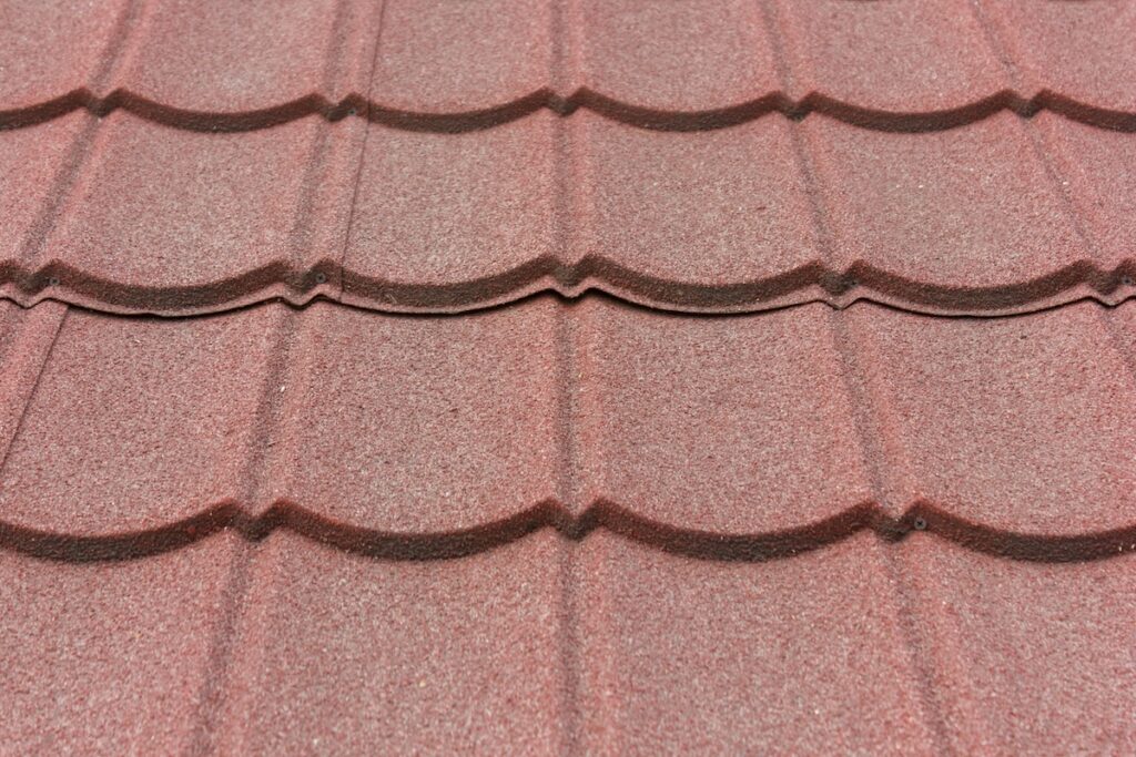 Texture of stone coated steel roof tiles in red color