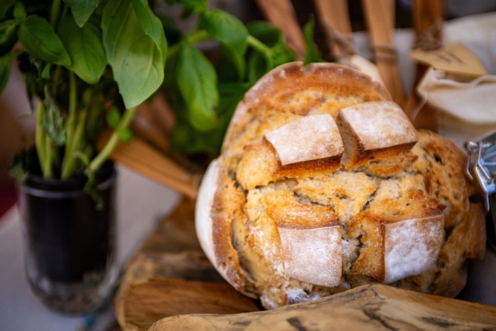 A close-up shot of a freshly baked, crusty loaf of artisanal round bread